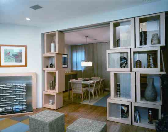 Designer Rick Harlan Schneider replaced a dividing wall with see-through display cabinets that bring light into the formerly dark dining room.